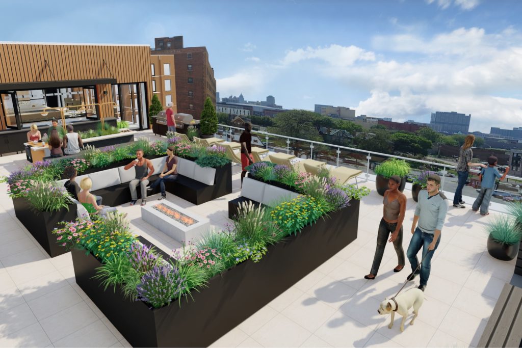 Rendering of Woodward West's rooftop terrace, featuring lots of greenery, seating and a skyline view of Detroit.